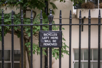 A sign, prohibiting the parking of a bicycle outside private property.
