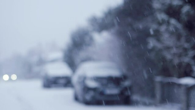 Blizzard - Heavy Snow Storm detail in SLOW MOTION HD VIDEO. Wild falling snowflakes in the wind. Slowly moving car through the street. Quarter speed.