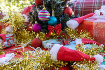 Christmas background with Santa hats, tinsel and Christmas tree