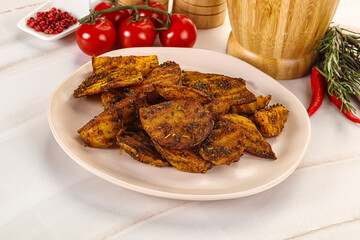 Golden baked potato Idaho with spices