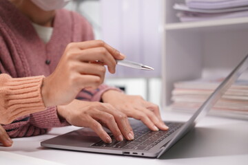 Two beautiful Asian employees enjoying successful work and confidently holding hands to work productively together at the office. Businessman, employee, African, laptop.