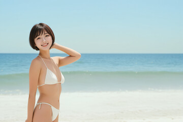 Fototapeta na wymiar 青空をバックに健康的に微笑むビキニ姿の若い日本人女性