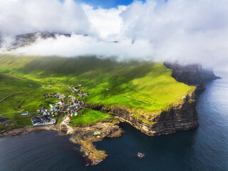 Faroe islands - Aerial panoramic view of the village of gjogv on cliffs washed by the ocean, Eysturoy island,  Denmark, Europe - 702647923