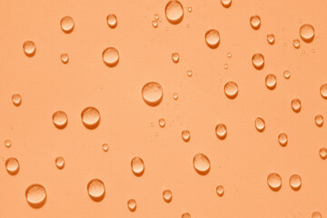 Water drops on a blue background. Cosmetic pattern with transparent drops of micellar water, serum,...