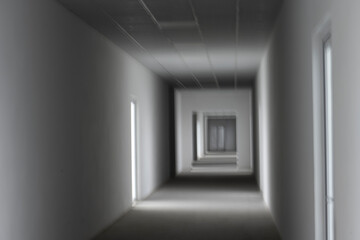 Obraz premium Empty corridor with light from the window. A light in the end of a tunnel