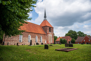 Fototapeta na wymiar Rysumer Kirche mit Friedhof