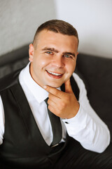 A stylish portrait of the groom preparing for the wedding ceremony in the morning. Groom's morning....