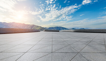 Empty square floor and green mountain with sky clouds at sunset