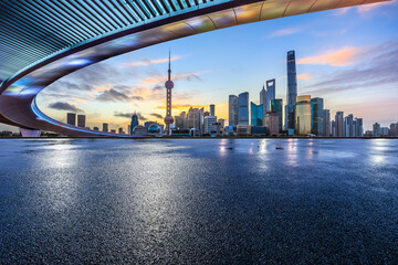 Asphalt road square and bridge with modern city buildings at sunrise in Shanghai