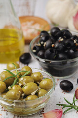 Black and green olives in glass bowls