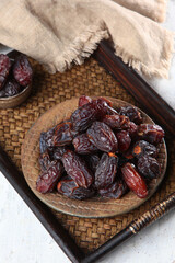 Large dates on a platter. A sweet snack for the Ramadan holiday. The fruits of the date palm.