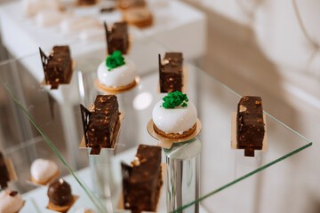 Almond cookies and various sweet cakes for a wedding banquet. A delicious reception, a luxurious ceremony. Table with sweets and desserts. Delicious colorful French desserts on a plate or table.