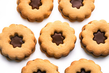 Traditional Christmas Linzer cookies biscuits with shortcrust pastry and jam filling on white background, food textured backdrop