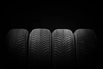 Fotobehang Car tires, winter wheels isolated on black background, transport transportation business industry © ValentinValkov