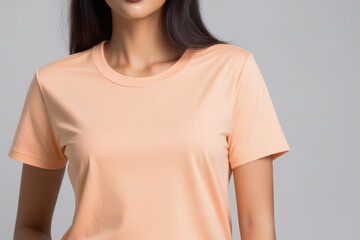 Woman in peach fuzz colored tshirt, can be used for design, mock up. The trending color of 2024.