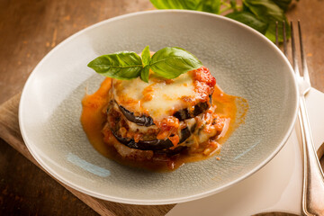 eggplants parmigiana with basil leaves