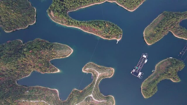Aerial view of thousands of islands in Qiandaohu lake in Chunan, Hangzhou, Zhejiang, China. Colorful islands and peaceful lake, beautiful natural landscape, 4k real time footage, drone view.