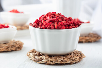 Dried goji berries on a white table.
