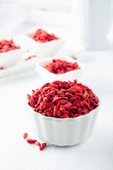 Dried goji berries on a white table.