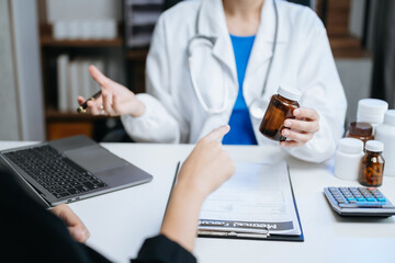 Healthcare costs and fees concept.Hand of smart doctor used a calculator and smartphone, tablet for medical costs