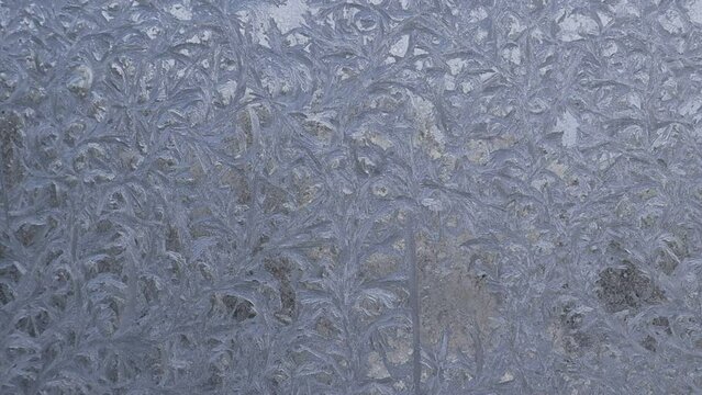 A frozen window close-up. Frosty drawing on the window