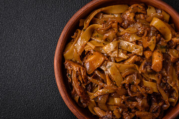 Delicious asian udon dish with vegetables, mushrooms, salt and spices