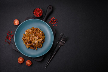 Delicious asian udon dish with vegetables, mushrooms, salt and spices