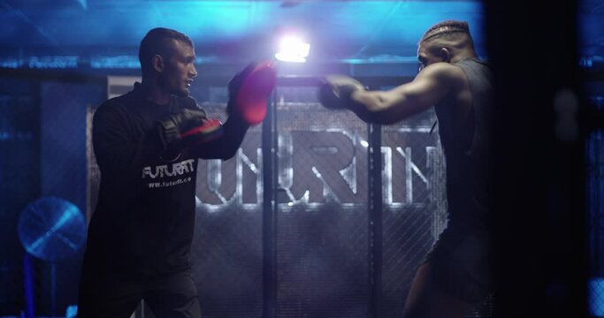 Boxer, coach or fighter at gym in exercise or workout for fitness or wellness for power or action. Arena, sports or personal trainer with athlete in training for boxing development or fighting skills