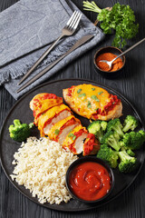 baked chicken breasts with rice, broccoli on plate