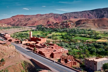 beautiful view over a lush green moroccan valley in the Atlas Mountains, blue sky, lonely wanderer, North Africa 