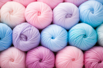 Top view of many pastel colored balls of wool