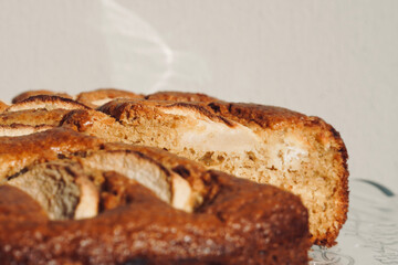 Homemade sliced fruit cake on white background. 