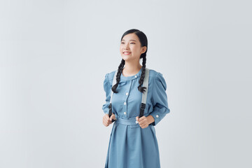 Young asian woman portrait in blue dress. Soft sunny colors.