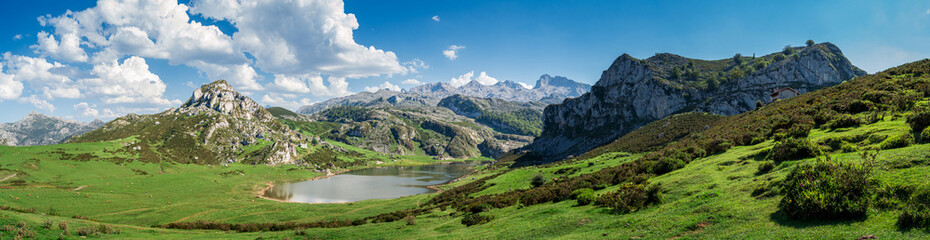Naklejka na ściany i meble Scenic view of Covadonga Lakes in Asturias, Spain against a cloudy blue sky