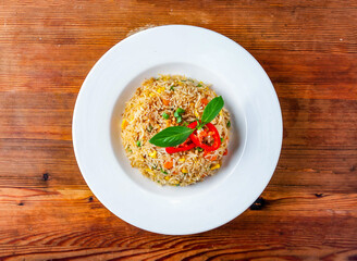 Egg vegetable fried rice served in dish isolated on wooden table top view of hong kong food