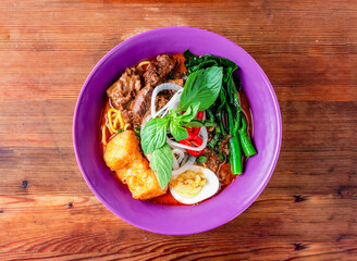 wagyu beef vegetable noodle soup served in dish isolated on wooden table top view of hong kong food