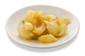 Cooked onions seasoned with olive oil in white plate isolated