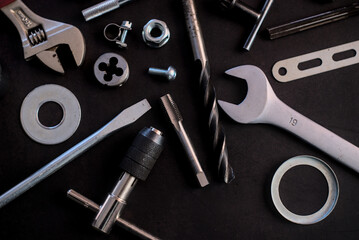 Fototapeta premium Many different tools for repair work on a black background.