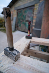 two heavy stonecutter hammers on working table in workshop yard