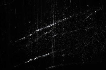 Abstract background. The shine of wet polyethylene. Synthetic glitter on black