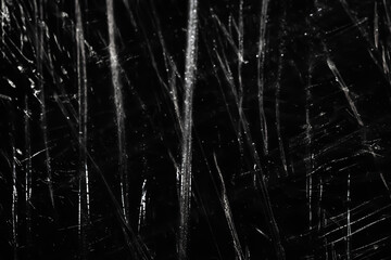 Abstract background. Polyethylene shine. Glittering drops. Synthetic shine on black