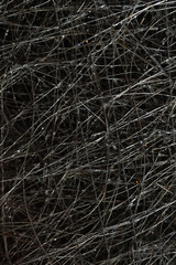 Abstract background. Tangled wire close-up. Macro image of a dark wire