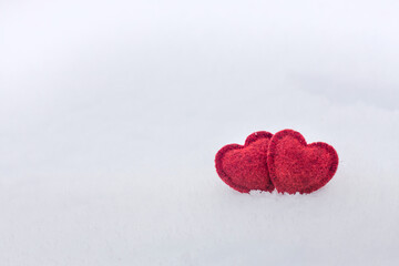 Two Red hearts on snow in winter. Happy valentines day celebration. Heart love concept.