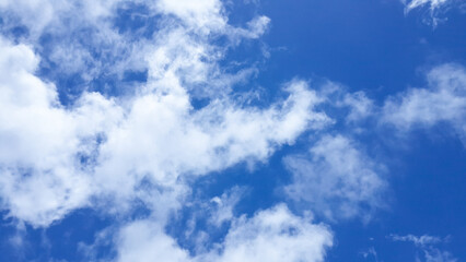 Naklejka na ściany i meble Clouds dissipitating on a blue sky background
