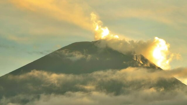 Lockdown Slow Motion Shot Of Clouds Moving Around Volcanic Mountain During Tranquil Sunset - Java, Indonesia