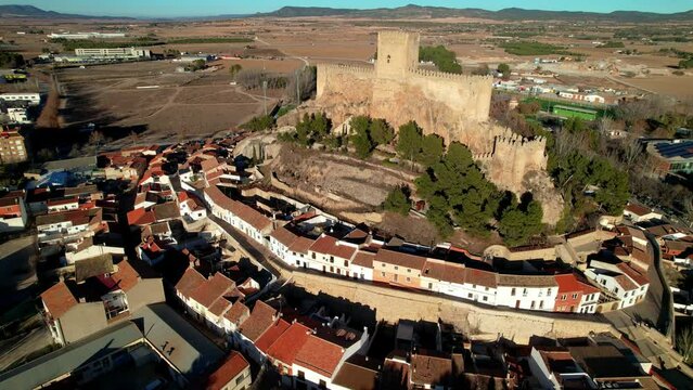 Spain Almansa castle and village aerial drone view 4K. Round townscape architecture. Historic Spanish town with medieval fortress on hilltop. Castile-La Mancha travel 