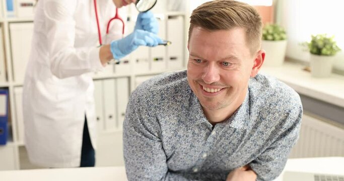 Doctor proctologist taking out toy car from rectum of male patient 4k movie slow motion. Rectal foreign bodies concept