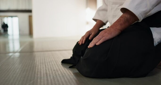 Asian man, student or bow in dojo for respect, greeting or honor to master at indoor gym. Closeup of male person or karate trainer bowing for etiquette, attitude or commitment in martial arts class