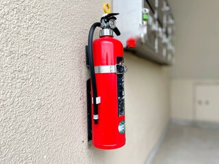 fire extinguisher installed on an apartment wall