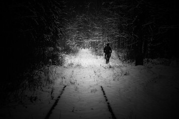 WINTER ATTACK - An old railway road covered with snow and a cyclist on forest road